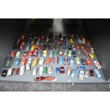 A shelf of playuworn die-casts, Matchbox, Husky, Guisval etc, most in good condition with little