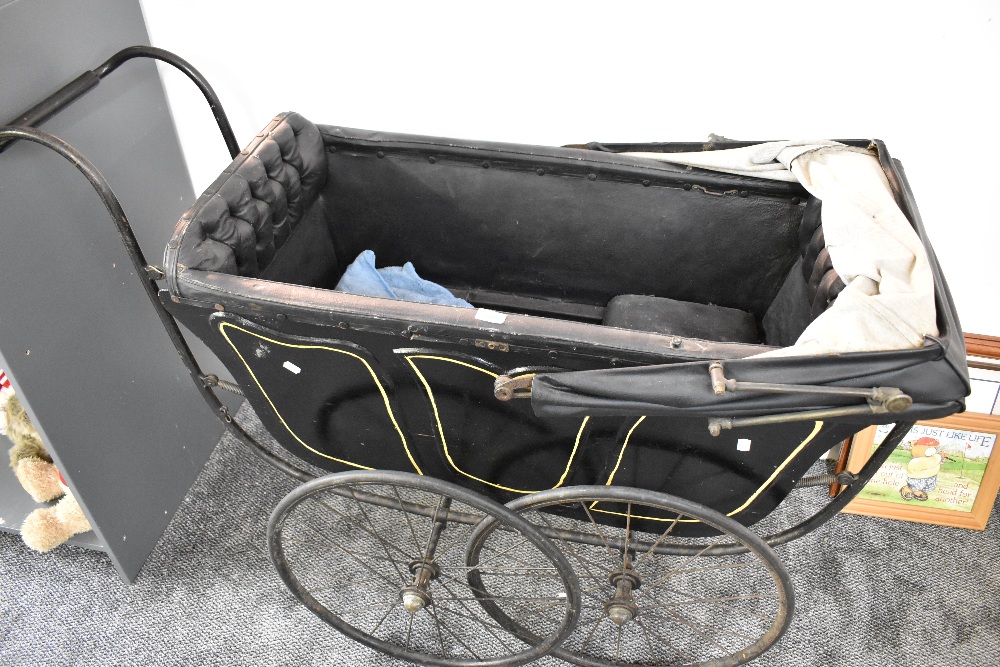 A Victorian Coach Built Childs Double Pram having spoked wheels and folding hood