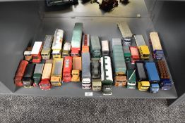 A shelf of Corgi and similar die-casts, Wagons, Articulated Trucks, etc
