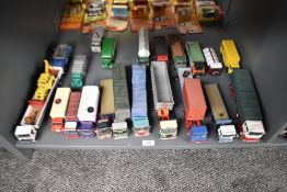 A shelf of Corgi and similar die-casts, Wagons, Articulated Trucks, etc