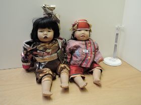 Two German rubber Gotz Dolls, both marked Carlos, both wearing Oriental dress, lengths approx 55cm