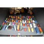 A shelf of playworn die-casts, Corgi, Spot-On, Dinky, Guisval etc, most in good condition with