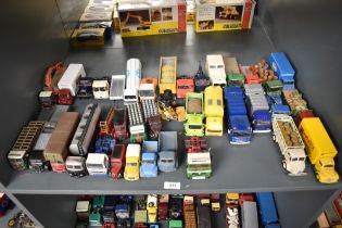 A shelf of Corgi and similar die-casts, Wagons, Trucks, Vans etc