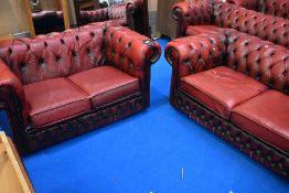 Two red leather button back Chesterfield two seater settees