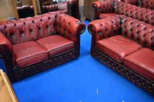 Two red leather button back Chesterfield two seater settees