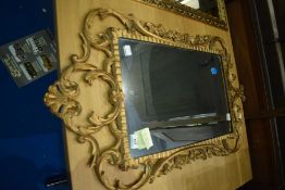 A vintage rococo style gilt wall mirror, approx 87 x 45cm