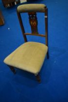 A Victorian mahogany nursing chair having shield back and later dralon upholstery