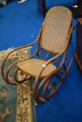 A bentwood rocking chair having canework seat and back