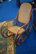 A bentwood rocking chair having canework seat and back