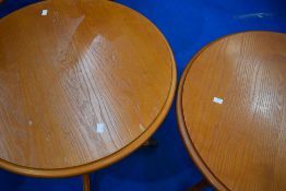 A pair of reproduction Regency style yew effect occasional tables, diameter approx. 71cm