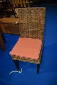 A set of twelve hardwood and wicker dining chairs