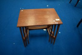 A vintage teak laminate nest of three tables of stylised form, approx W57 D41 H51cm, stamped to base