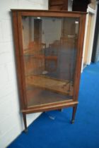 An early 20th Century oak corner display, having adjustable glass shelves (corner chip to one)