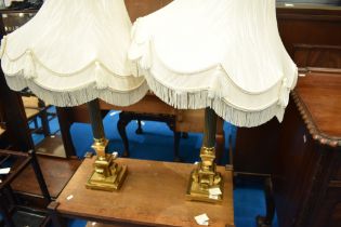 A pair of brass Corinthian style table lamps