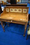 A Victorian pine wash stand with tiled back, having frieze drawer and turned legs, dimensions