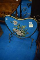 An Art Nouveau style mirrored fire screen with painted flora decoration, height approx. 70cm