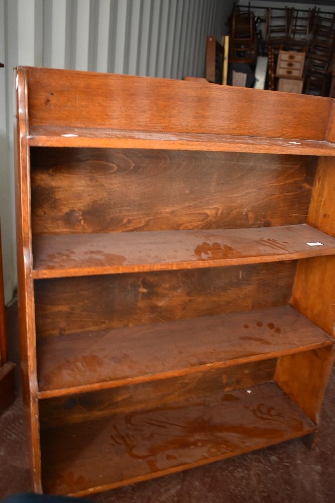 An early 20th Century oak waterfall bookshelf, dimensions approx W76 D17 H93cm