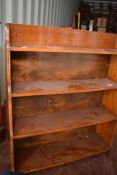 An early 20th Century oak waterfall bookshelf, dimensions approx W76 D17 H93cm