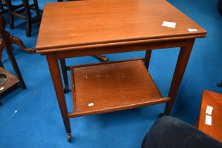 A vintage teak fold over tea trolley, width card table top, labelled Eastcraft , similar to