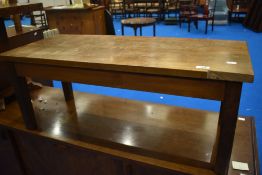 A vintage mahogany and oak coffee table having rectangular top , damaged to corner, in the Arts