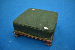 A 19th Century upholstered footstool of square form , having mahogany frame with rosette feet, width