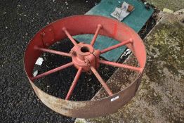 A large vintage cast pulley wheel