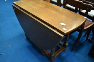 A vintage oak gateleg dining table on turned frame, width approx 114cm