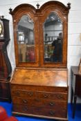 A fine Queen Anne walnut bureau , having double arch topped, Italian style mirrored panels to doors,