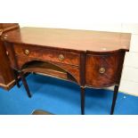 A Regency mahogany sideboard having central drawer above recess , flanked by cupboard , cellarette