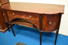 A Regency mahogany sideboard having central drawer above recess , flanked by cupboard , cellarette