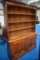 A Victorian pitch pine bookshelf with cupboard under, approx height 230cm, width 173cm, depth 31cm