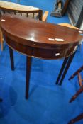 An early to mid 20th Century mahogany demi lune fold over tea tables, width approx 75cm