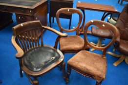 An oak office armchair having slat back and a pair of Victorian balloon back chairs