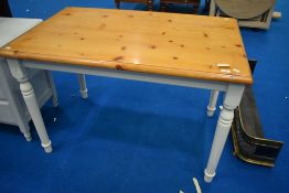A vintage pine kitchen table having painted legs, approx 120 x 76cm