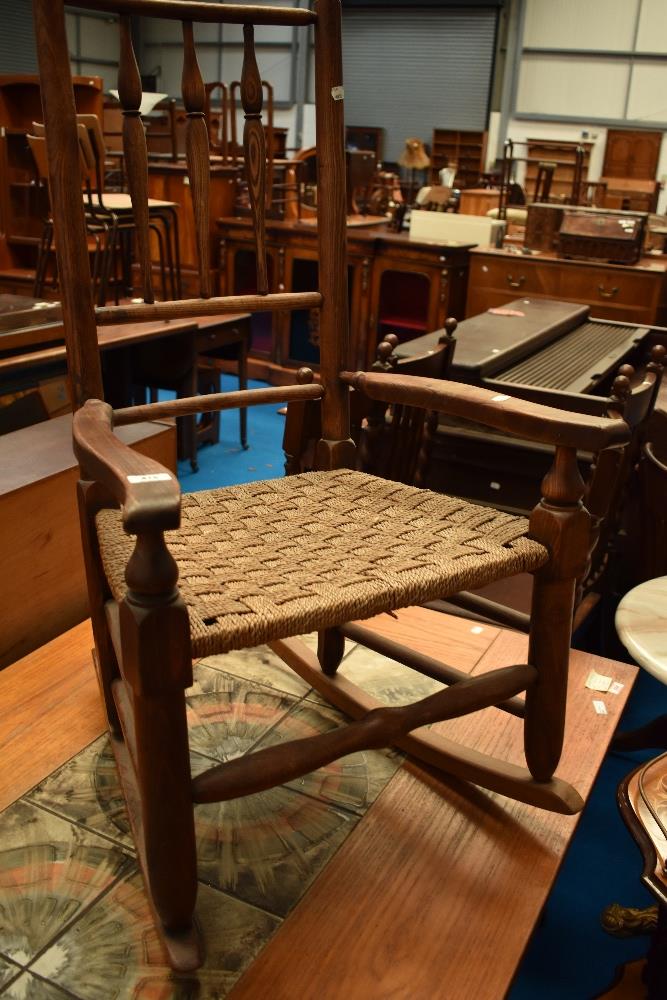 A 19th Century rocking chair having triple spindle back and strung seat