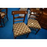 A pair of 19th Century railback dining chairs with later woolwork seats