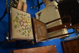 An early 20th Century cane seated chair and a tapestry footstool