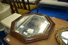 An early 20th Century oak wall mirror of octagonal form, diameter approx 44cm