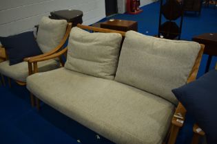 An Ercol or similar lounge suite comprising two settees and one armchair