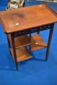 An Oriental ifluenced occasional table with alternating undershelves, width approx. 59cm