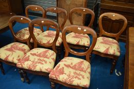 A set of six Victorian balloon back dining chairs with later upholstery