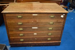 A vintage plan chest having five drawers, with brass handles, approx width 128cm, on plinth base