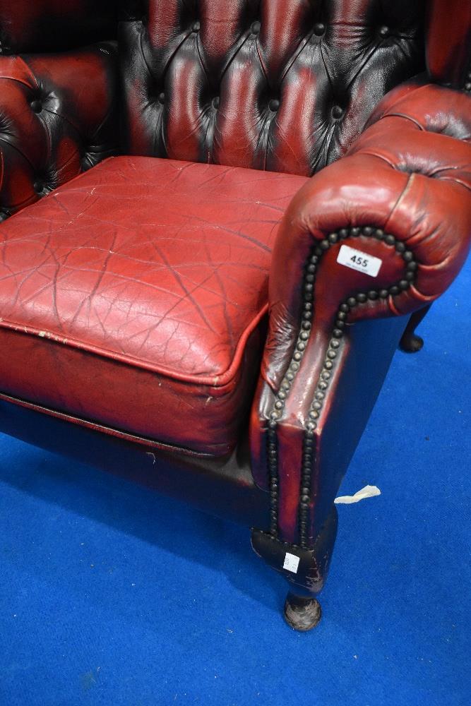 A red leather button back wing armchair - Image 2 of 3