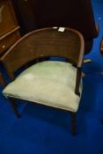 A vintage stained frame tub chair havig cane effect back