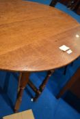 An oak occasional table having oval top, with folding frame, approx. 92 x 75cm