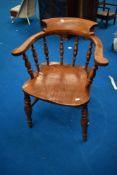 A traditional captains style elbow chair