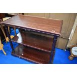 A traditional stained frame serving table, having undertier and lower shelf, on castors, approx