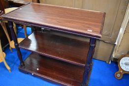 A traditional stained frame serving table, having undertier and lower shelf, on castors, approx