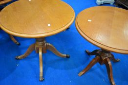 A pair of reproduction Regency style yew effect occasional tables, diameter approx. 71cm, one with