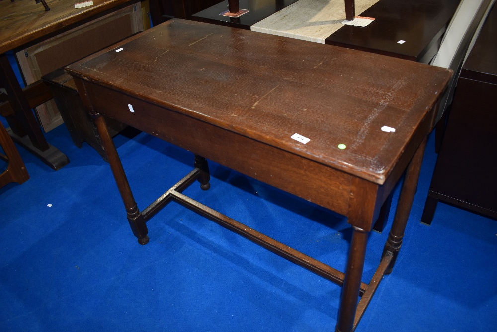 A traditional oak side table on turned H frame, approx 99 x 48cm, height 81cm